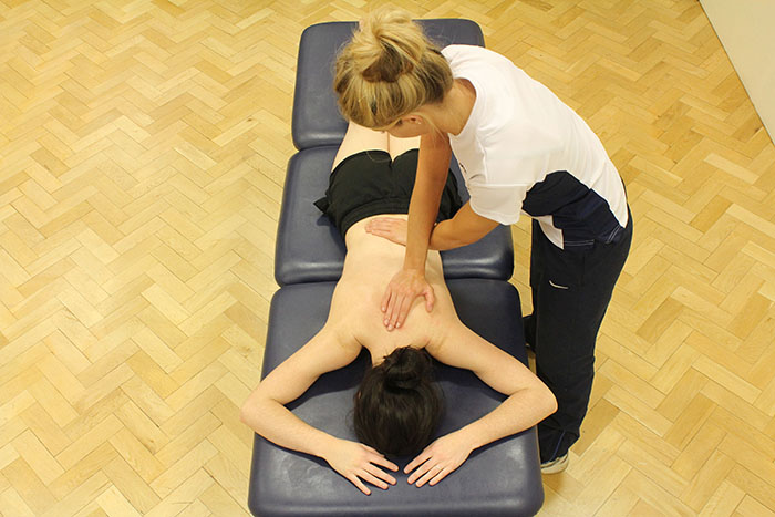 Myofascial release technique on customers back in Manchester clinic