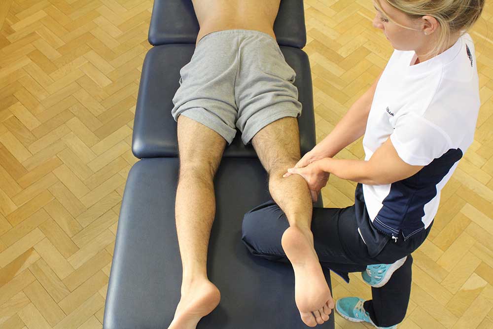 Trigger point massage of gastrocnemius to release knotted muscle and tightness